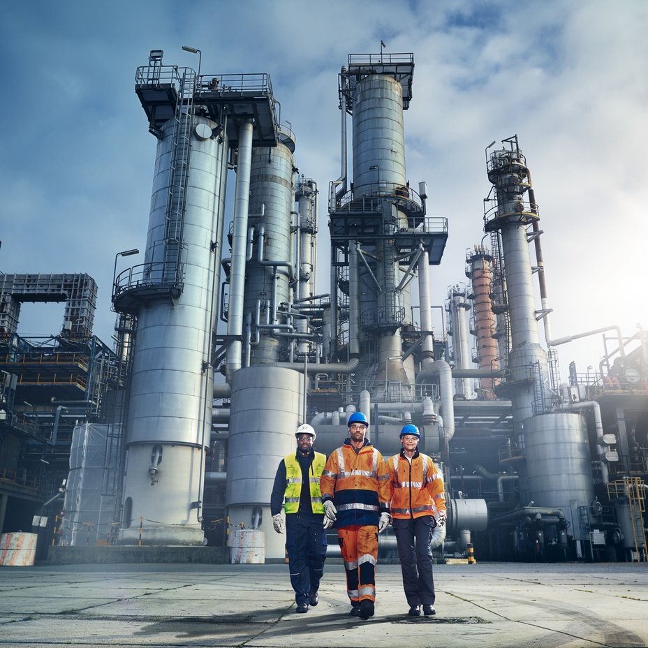 Fotografía en primer plano de una  ingeniera de Endress+Hauser delante de una refinería